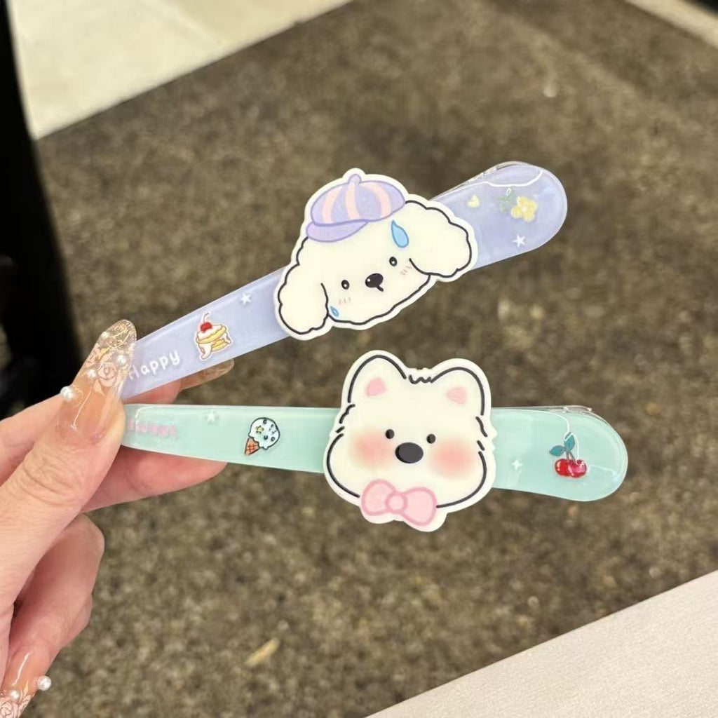 Close-up of puppy and bear kawaii hair clips in lavender and mint
