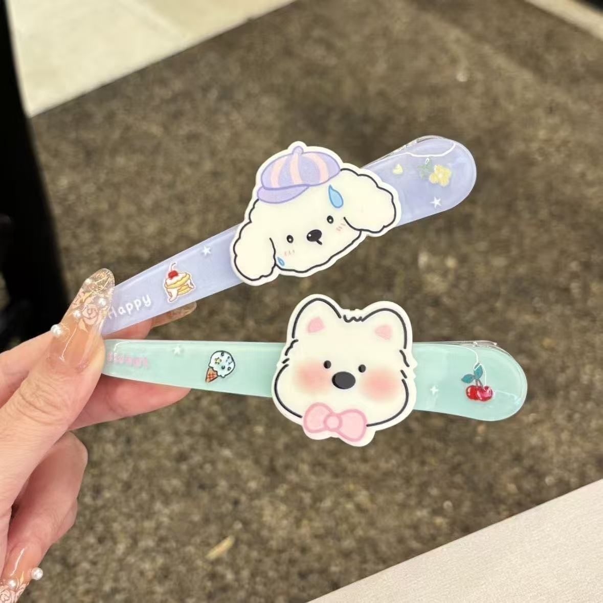 Close-up of puppy and bear kawaii hair clips in lavender and mint