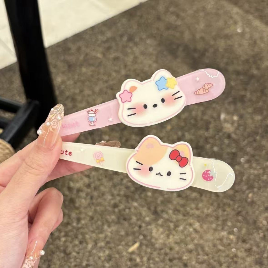 Close-up of star kitty and bow kitty acrylic hair clips
