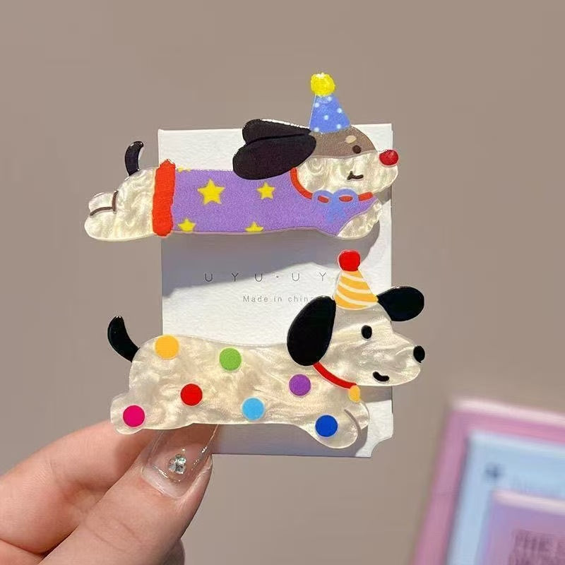 Two Party Animal dog hair clips on packaging card — purple star and polka-dot designs
