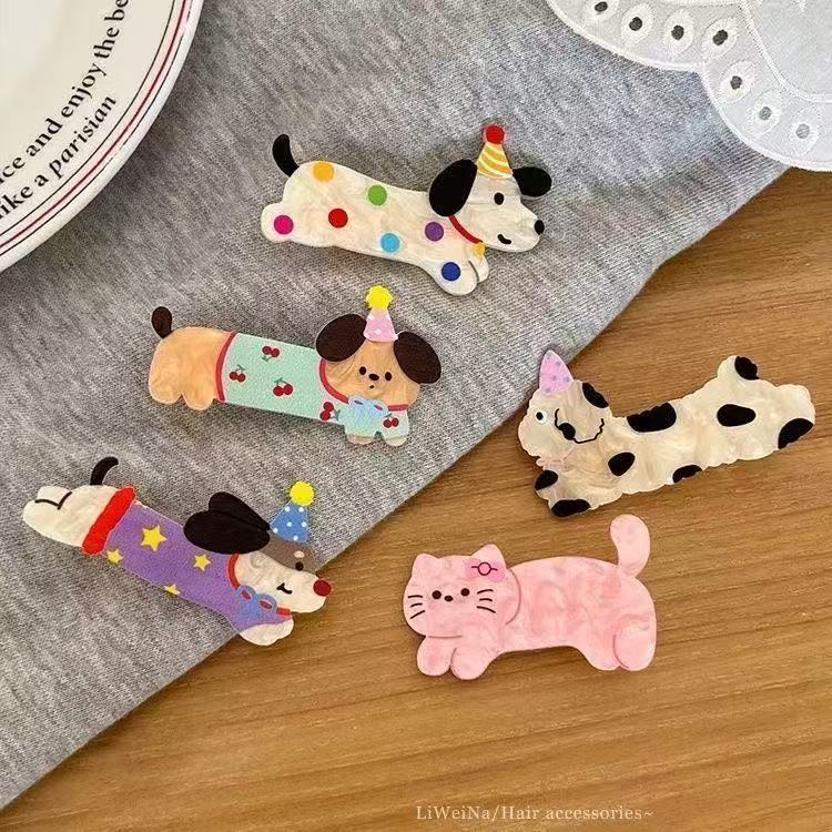 Five Party Animal acrylic hair clips laid flat on fabric showing all designs